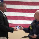 Kenai Elks Lodge Exalted Ruler Allen Burkett presents Kenai Fire Departments Pete Coots with an award at the Kenai Elks Lodge in Kenai, Alaska, on Friday, Oct. 6, 2023. (Jake Dye/Peninsula Clarion)