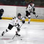 Kenai Rivers Joe Manning moves with the puck, pursued by Anchorages Taisetsu Ushio during a hockey game at the Soldotna Regional Sports Complex in Soldotna, Alaska, on Saturday, Oct. 7, 2023. (Jake Dye/Peninsula Clarion)