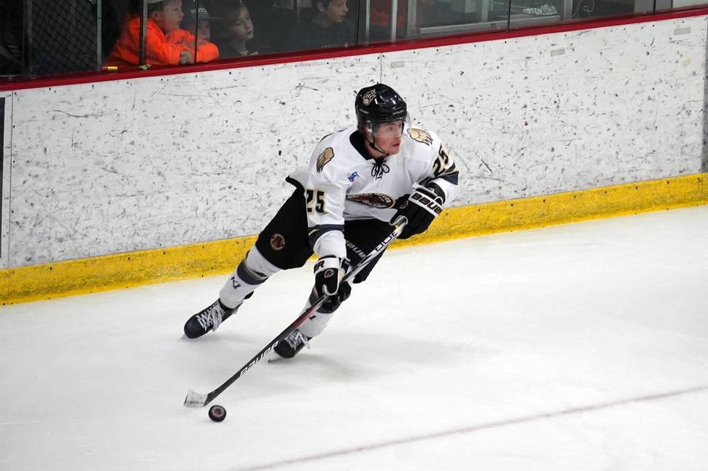 Kenai Rivers John Ross takes control of the puck during a hockey game at Soldotna Regional Sports Complex in Soldotna, Alaska, on Saturday, Oct. 7, 2023. (Jake Dye/Peninsula Clarion)