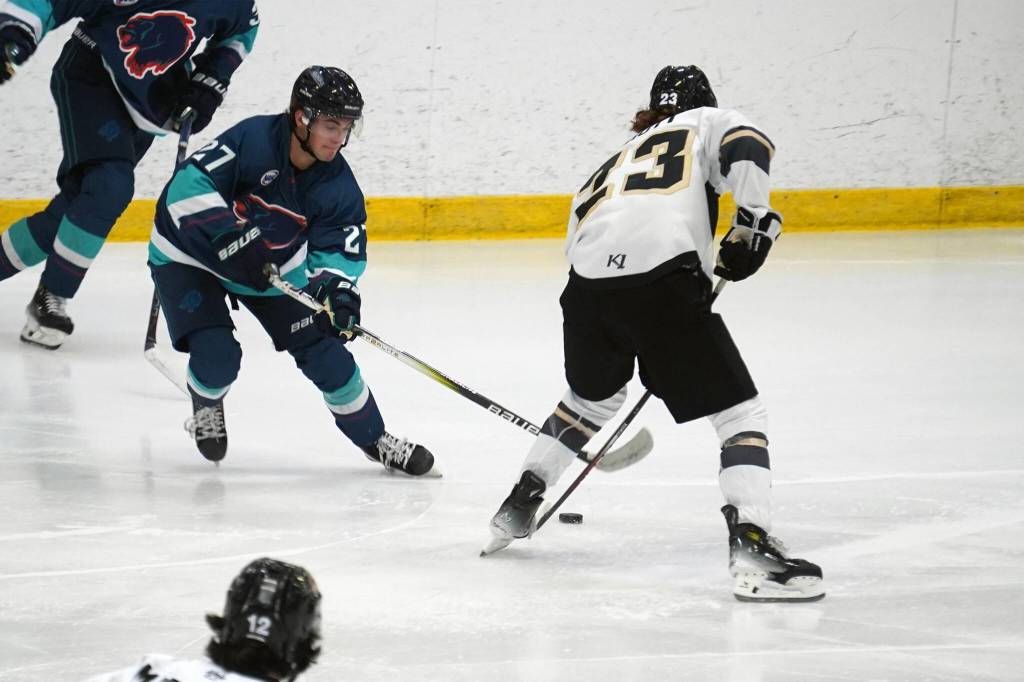 Anchorages Danny Bagnole and Kenai Rivers Jackson Ebbott battle for the puck during a hockey game at the Soldotna Regional Sports Complex in Soldotna, Alaska, on Saturday, Oct. 7, 2023. (Jake Dye/Peninsula Clarion)