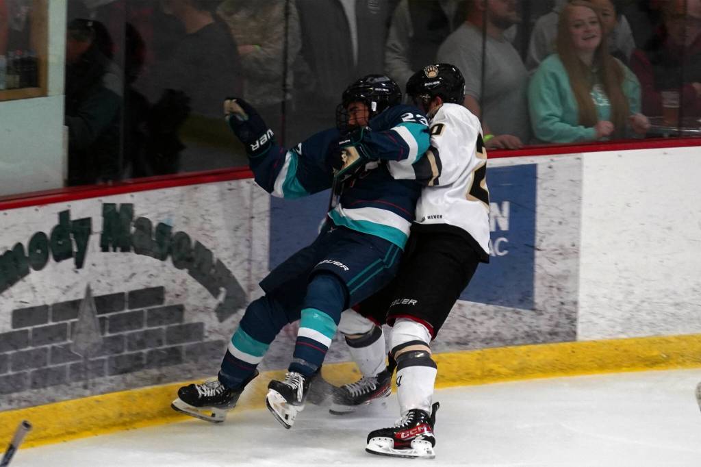 Kenai Rivers Tiziano Pauchard slams Anchorages Taisetsu Ushio into the wall during a hockey game at the Soldotna Regional Sports Complex in Soldotna, Alaska, on Saturday, Oct. 7, 2023. (Jake Dye/Peninsula Clarion)