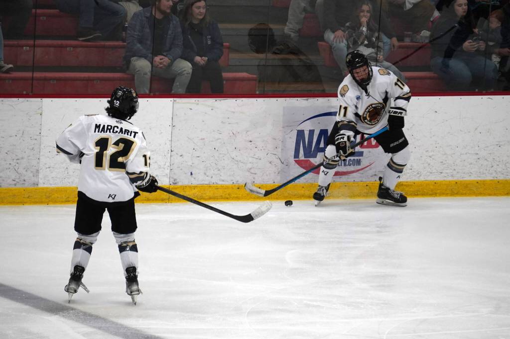 Kenai Rivers Cade Baker, right, takes control of the puck during a hockey game at the Soldotna Regional Sports Complex in Soldotna, Alaska, on Saturday, Oct. 7, 2023. (Jake Dye/Peninsula Clarion)