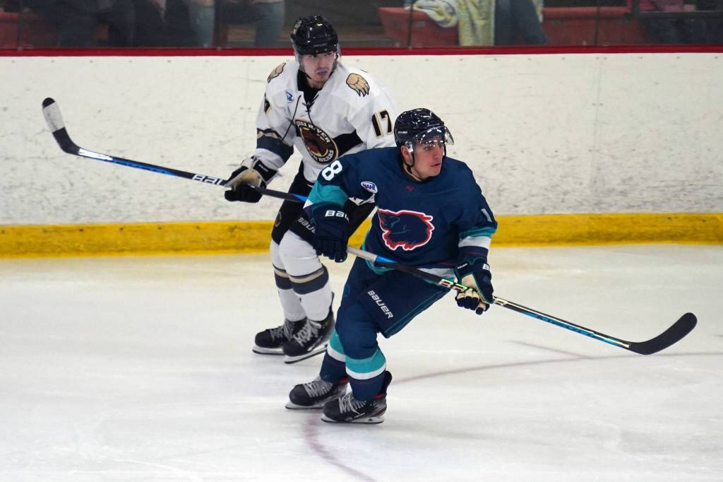 Kenai Rivers Owen Hanson and Anchorages Mason Lebel lock eyes on the puck during a hockey game at the Soldotna Regional Sports Complex in Soldotna, Alaska, on Saturday, Oct. 7, 2023. (Jake Dye/Peninsula Clarion)