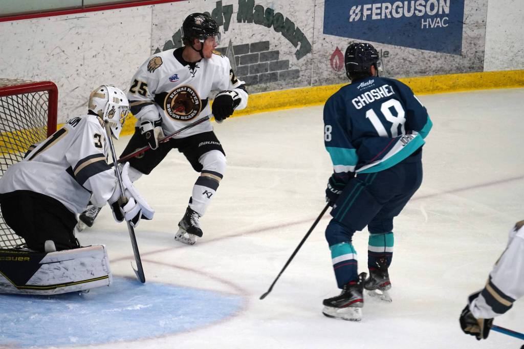 Kenai Rivers Peter Wickström Stumer and John Ross move to defend the goal as Anchorage Wolverines move to shoot during a hockey game at the Soldotna Regional Sports Complex in Soldotna, Alaska, on Saturday, Oct. 7, 2023.