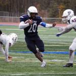 Soldotnas Andon Wolverton runs with the ball while fending off North Poles Gage Runnels in the Division II semifinal at Justin Maile Field in Soldotna, Alaska, on Saturday, Oct. 14, 2023. (Jake Dye/Peninsula Clarion)