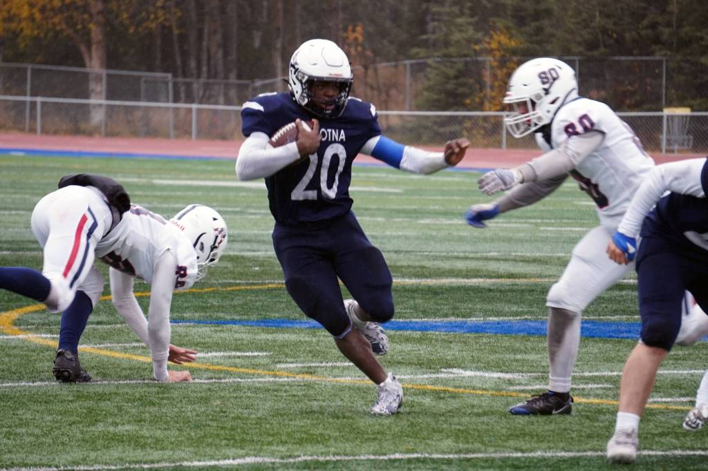 Soldotnas Andon Wolverton runs with the ball while fending off North Poles Gage Runnels in the Division II semifinal at Justin Maile Field in Soldotna, Alaska, on Saturday, Oct. 14, 2023. (Jake Dye/Peninsula Clarion)