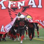 Sawyer Vann leads Kenai Central to the field Saturday, Oct. 14, 2023, in the Division III state championship game at Service High School in Anchorage, Alaska. (Photo by Jeff Helminiak/Peninsula Clarion)
