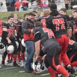 Kenai Central assistant coach Blake Taplin celebrates victory with the team Saturday, Oct. 14, 2023, in the Division III state championship game at Service High School in Anchorage, Alaska. (Photo by Jeff Helminiak/Peninsula Clarion)