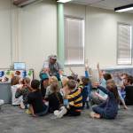 Jessie Soyangco, speaks to a class of kindergarteners at Kaleidoscope School of Arts and Science in Kenai, Alaska, on Thursday, Oct. 19, 2023. (Jake Dye/Peninsula Clarion)
