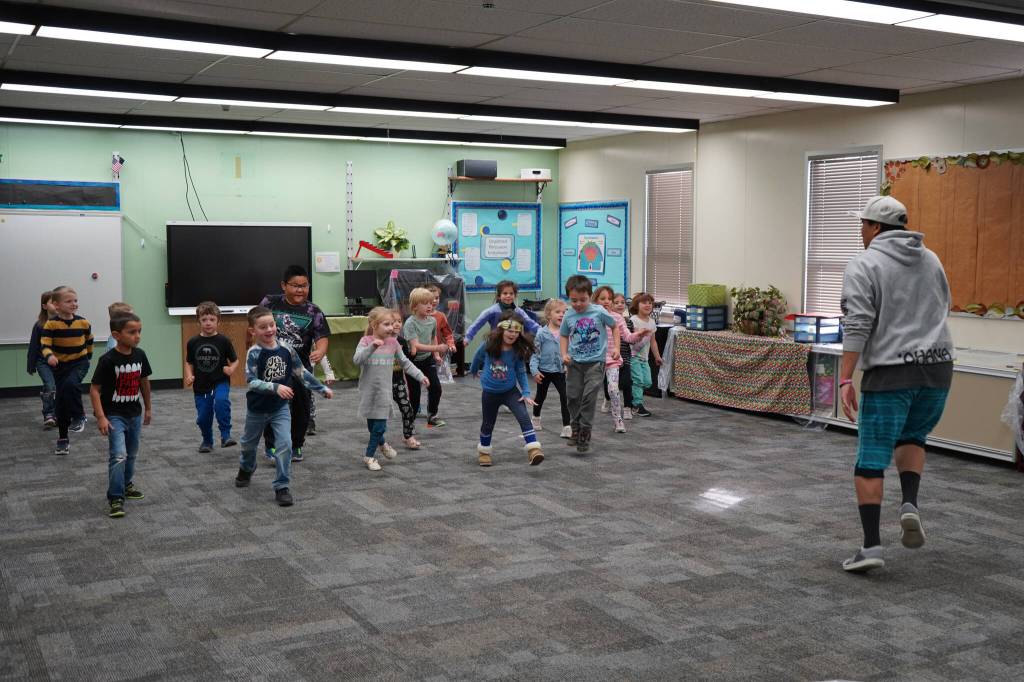 Jessie Soyangco, right, leads a class of kindergarteners in dancing to a remix of the Little Einsteins theme song at Kaleidoscope School of Arts and Science in Kenai, Alaska, on Thursday, Oct. 19, 2023. (Jake Dye/Peninsula Clarion)