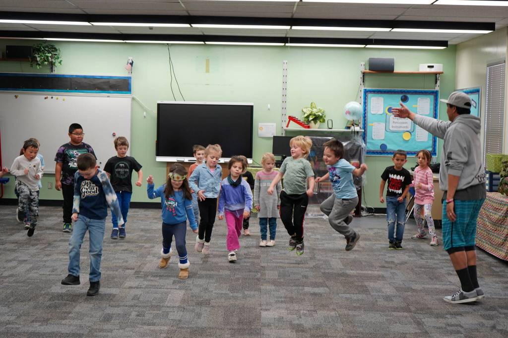 Jessie Soyangco, right, leads a class of kindergarteners in dancing to a remix of the Little Einsteins theme song at Kaleidoscope School of Arts and Science in Kenai, Alaska, on Thursday, Oct. 19, 2023. (Jake Dye/Peninsula Clarion)