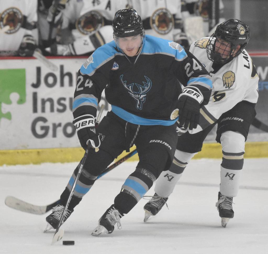 Cashen Naeve of the Wisconsin Windigo shields the puck from Andy Larson of the Kenai River Brown Bears on Friday, Oct. 20, 2023, at the Soldotna Regional Sports Complex in Soldotna, Alaska. (Photo by Jeff Helminiak/Peninsula Clarion)