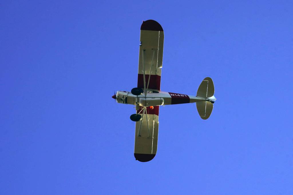 A pumpkin is released from a plane during Kenai Aviations Fifth Annual Pumpkin Drop at the Kenai Airpark in Kenai, Alaska, on Saturday, Oct. 21, 2023. (Jake Dye/Peninsula Clarion)