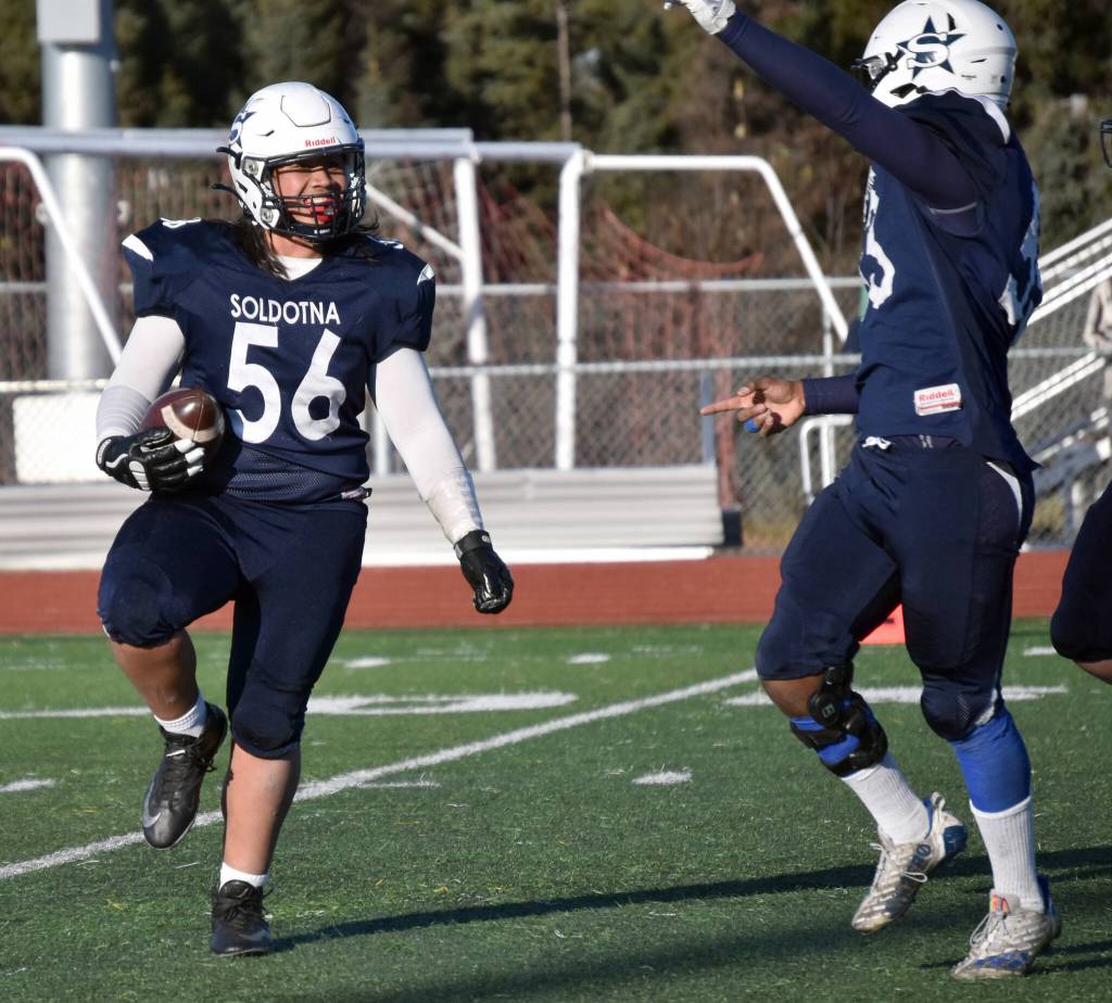 Soldotnas Koda Lepule celebrates a fumble recovery with Elijah Lee on Saturday, Oct. 21, 2023, in the Division II championship game at Service High School in Anchorage, Alaska. (Photo by Jeff Helminiak/Peninsula Clarion)