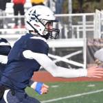 After handing to Soldotnas Gehret Medcoff for a 91-yard touchdown run, quarterback Zac Buckbee fakes a handoff to Collin Peck on Saturday, Oct. 21, 2023, in the Division II championship game at Service High School in Anchorage, Alaska. (Photo by Jeff Helminiak/Peninsula Clarion)