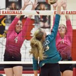 Kenai Centrals Avia Miller and Grace Beiser put up a block on Nikiskis Mandee Roofe on Tuesday, Oct. 24, 2023, at Kenai Central High School in Kenai, Alaska. (Photo by Jeff Helminiak/Peninsula Clarion)