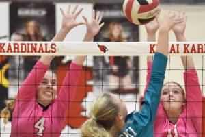 Kenai Central's Avia Miller and Grace Beiser put up a block on Nikiski's Mandee Roofe on Tuesday, Oct. 24, 2023, at Kenai Central High School in Kenai, Alaska. (Photo by Jeff Helminiak/Peninsula Clarion)