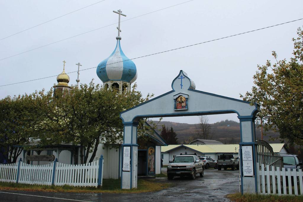 Ashlyn OHara/Peninsula Clarion
An arch marks the entrance to the Church of St. Nicholas on Oct. 10 in Nikolaevsk. In rear, cars are parked in front of a building that has been used this school year as a makeshift classroom for families who are part of a home-school cooperative.