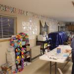 Community members gather in a building part of the Church of St. Nicholas, out of which a school cooperative runs, during a meeting on Tuesday, Oct. 10, 2023 in Nikolaevsk, Alaska. In rear, cars are parked in front of a building that has been used this school year as a makeshift classroom for families who are part of a home-school cooperative. (Ashlyn OHara/Peninsula Clarion)