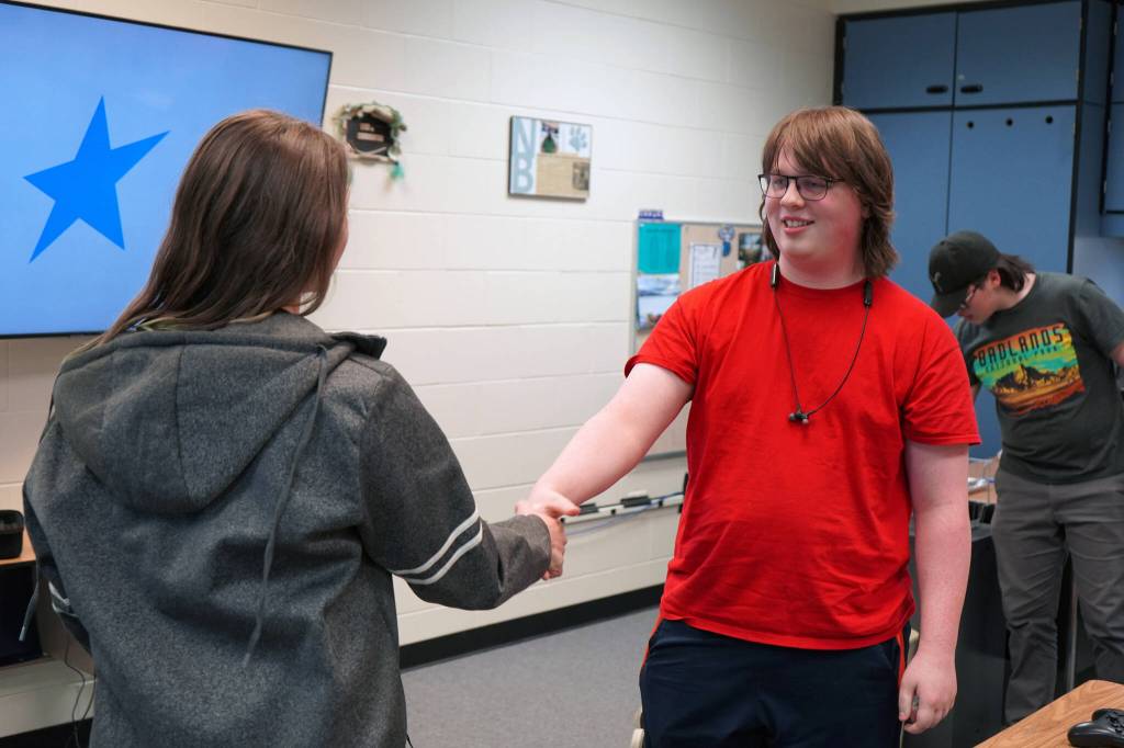 Lincoln Kimbell shakes hands with Boyd Lehmberg after winning the final round of a Super Smash Bros. Ultimate match at Nikiski Middle/High School in Nikiski, Alaska, on Monday, Oct. 23, 2023. (Jake Dye/Peninsula Clarion)