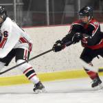 Kenai Centrals Braden Smith shields the puck from Houstons Brayden Spain on Thursday, Oct. 26, 2023, at the Kenai Multi-Purpose Facility in Kenai, Alaska. (Photo by Jeff Helminiak/Peninsula Clarion)