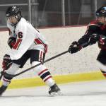 Kenai Central's Braden Smith shields the puck from Houston's Brayden Spain on Thursday, Oct. 26, 2023, at the Kenai Multi-Purpose Facility in Kenai, Alaska. (Photo by Jeff Helminiak/Peninsula Clarion)