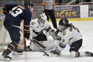 Hadley Hudak of the Springfield (Illinois) Jr. Blues tries to find a way through Kenai River Brown Bears goalie Conor Sullivan and defenseman Joe Manning on Friday, Oct. 27, 2023, at the Soldotna Regional Sports Complex in Soldotna, Alaska. (Photo by Jeff Helminiak/Peninsula Clarion)