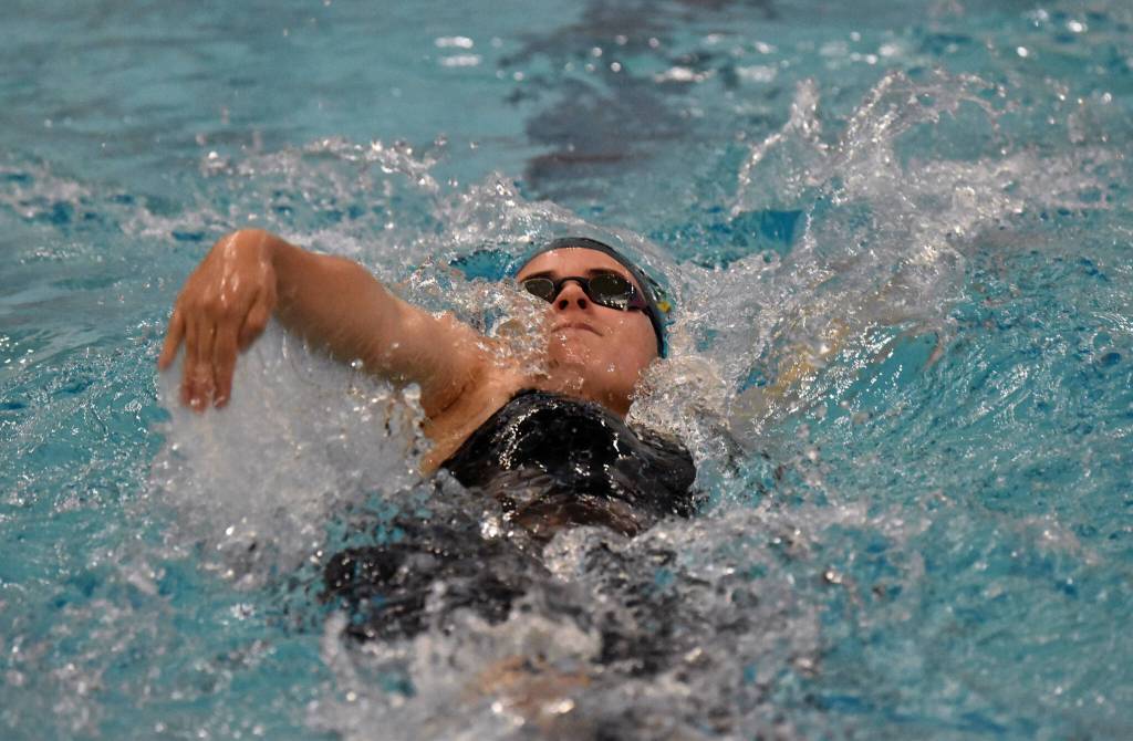 Homers Cassidy Carroll takes second in the 100-yard backstroke Saturday, Oct. 28, 2023, at the Northern Lights Conference swim meet at Soldotna High School in Soldotna, Alaska. (Photo by Jeff Helminiak/Peninsula Clarion)