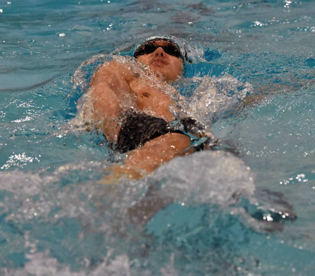 Sewards Nickolas Ambrosiani swims to victory in the 100-yard backstroke Saturday, Oct. 28, 2023, at the Northern Lights Conference swim meet at Soldotna High School in Soldotna, Alaska. (Photo by Jeff Helminiak/Peninsula Clarion)