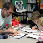 Hope School K-5 teacher Jeremy McKibben assists third grade students with reading skills part of CKLAs How Does Your Body Work? unit on Wednesday, Oct. 18, 2023, in Hope, Alaska. (Ashlyn OHara/Peninsula Clarion)