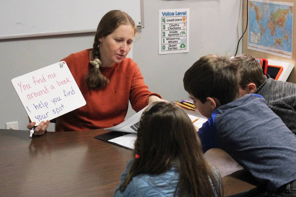 Jennifer Medley (left) practices literacy skills with students at Fireweed Academy on Tuesday, Oct. 17, 2023, in Homer, Alaska. (Ashlyn OHara/Peninsula Clarion)