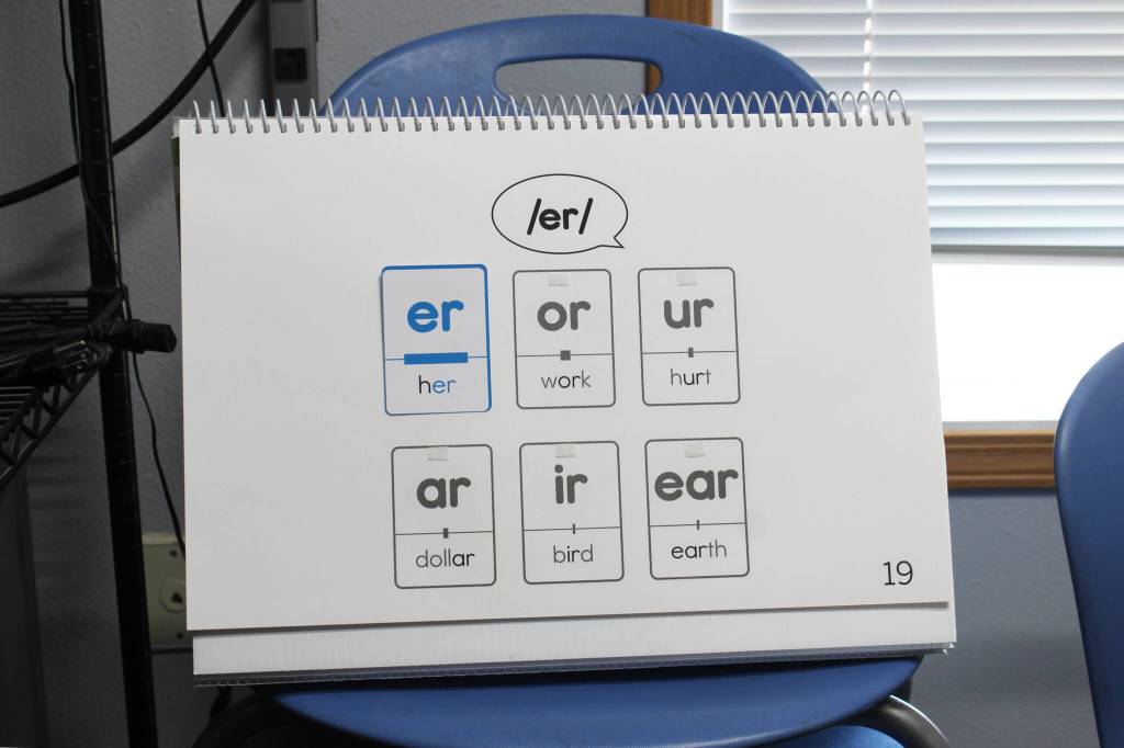 An Amplify CKLA flip book shows different ways to pronounce the sound /er/ inside Razdolna School Principal Dr. Mike Sturms office on Tuesday, Oct. 24, 2023, in Razdolna, Alaska. (Ashlyn OHara/Peninsula Clarion)