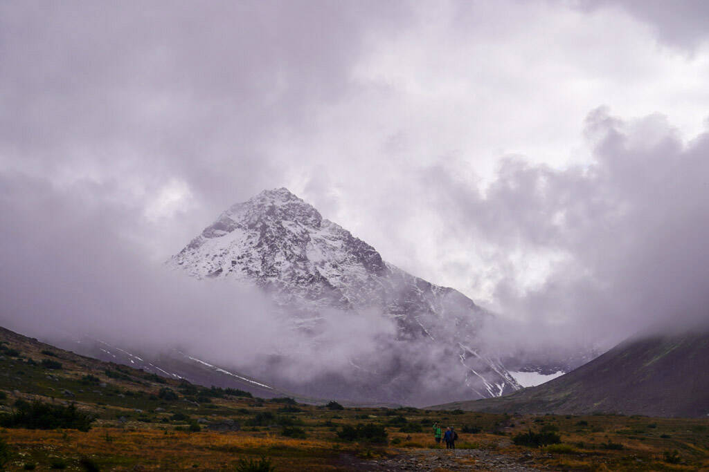 North Yuyanq Chex rises through heavy cloud cover over hikers on the Rabbit Lake Trail near Anchorage, Alaska, on Sunday, Sept. 24, 2023. Jake Dye didnt realize Rabbit Lake would be his last hike of the season, but in hindsight the hail should have been an indicator. (Jake Dye/Peninsula Clarion)