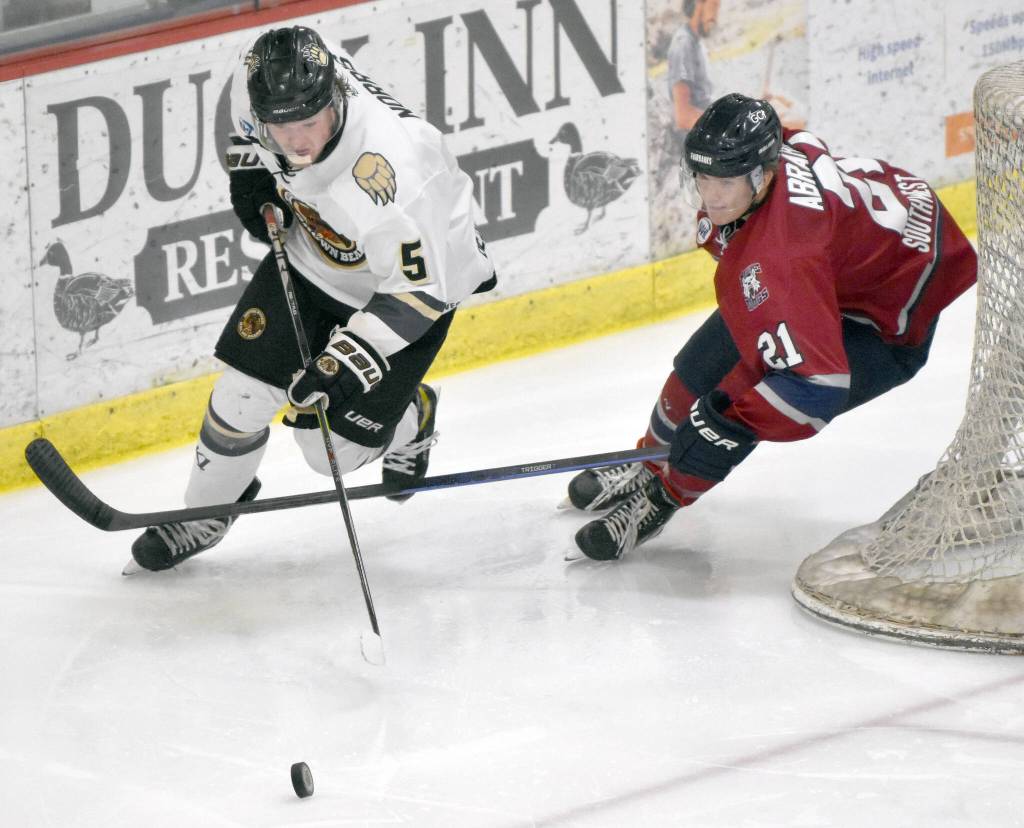 Blake Norris of the Kenai River Brown Bears tries to hold off Nolan Abraham of the Fairbanks Ice Dogs on Saturday, Nov. 4, 2023, at the Soldotna Regional Sports Complex in Soldotna, Alaska. (Photo by Jeff Helminiak/Peninsula Clarion)