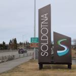 A sign welcoming people to the City of Soldotna stands near the intersection of the Sterling Highway and Kenai River on May 1, 2019, in Soldotna, Alaska. (Photo by Brian Mazurek/Peninsula Clarion)
