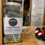 A tip jar collects money for Cooper Landing Emergency Services inside the Sunrise Cafe on Saturday, July 8, 2023 in Cooper Landing, Alaska. (Ashlyn OHara/Peninsula Clarion)