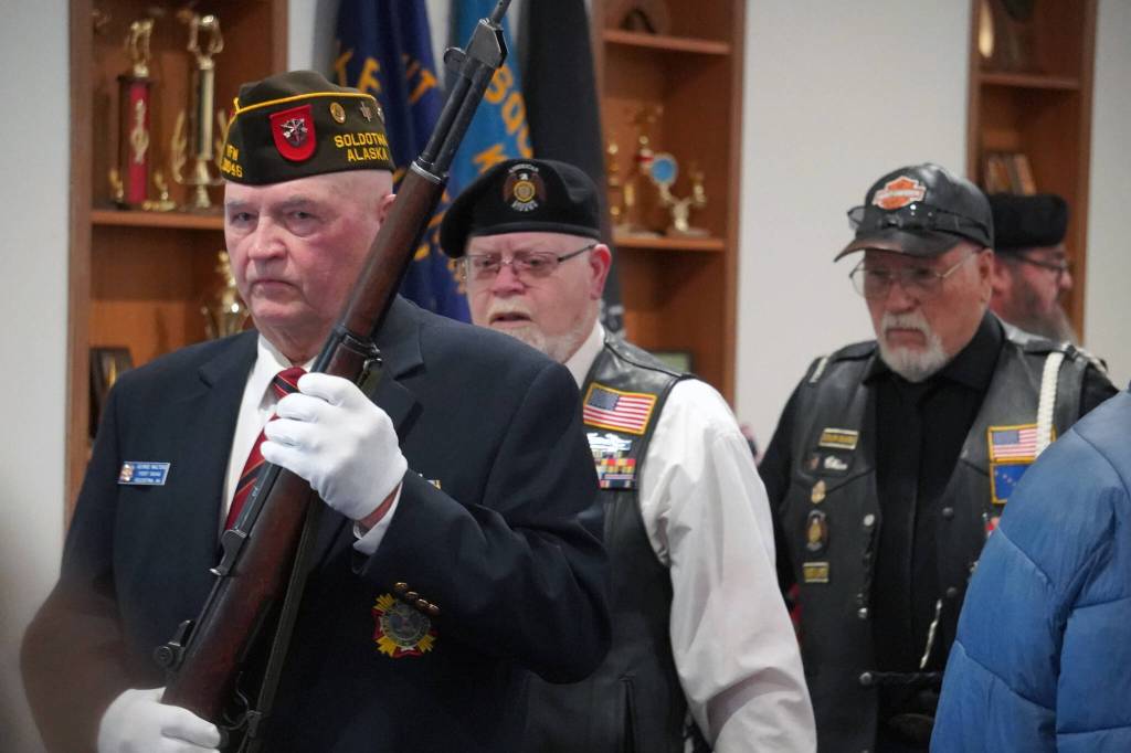 The American Legion Post 20s color guard proceeds through the dining space after posting colors at the American Legion Post 20 in Kenai, Alaska, on Saturday, Nov. 11, 2023. (Jake Dye/Peninsula Clarion)
