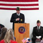American Legion Post 20 Cmdr. Ron Homan, center, is joined onstage by Past Cmdr. Dave Segura and Chaplain Mike Meredith while speaking during a Veterans Day celebration at the American Legion Post 20 in Kenai, Alaska, on Saturday, Nov. 11, 2023. (Jake Dye/Peninsula Clarion)