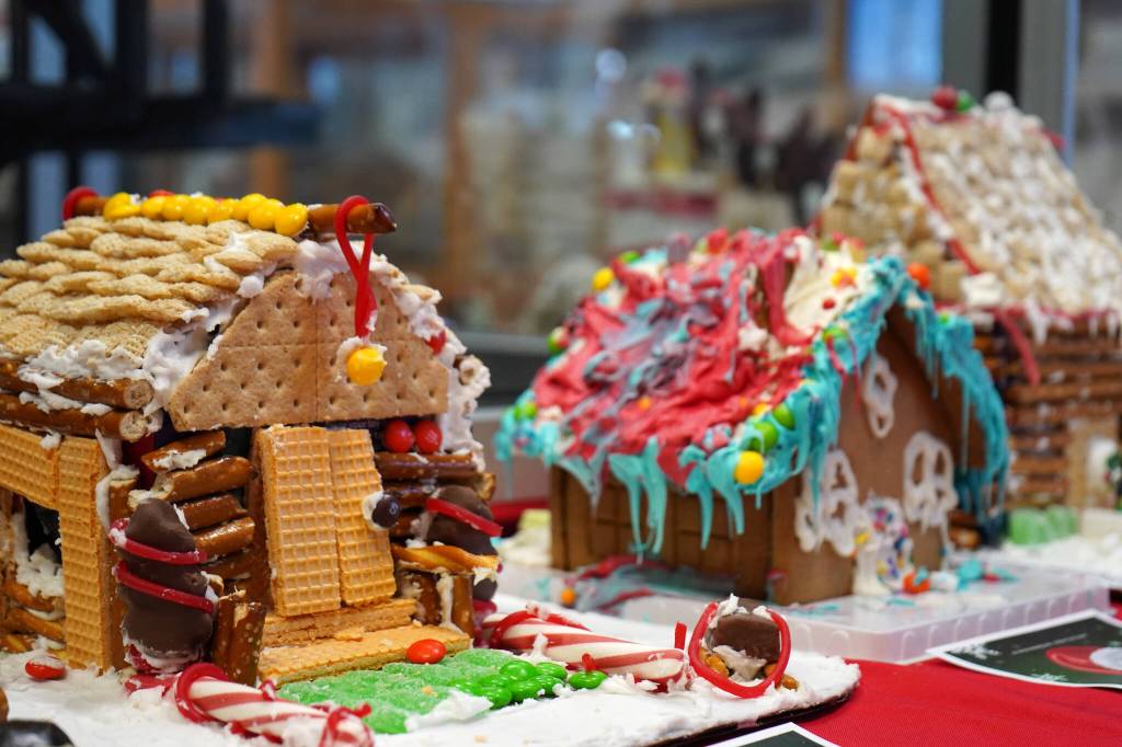 Gingerbread houses constructed by 7-year-olds Noah, Gavin and Tirzah are displayed as part of the 11th Annual Gingerbread House Contest at the Kenai Chamber of Commerce and Visitor Center in Kenai, Alaska, on Thursday, Nov. 16, 2023. (Jake Dye/Peninsula Clarion)