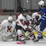 Kenai Central's Seanna Swanson scrambles to make a save while Cole Langham and Kylee Verkuilen hold off Palmer's Elijah Von Gunten on Thursday, Nov. 16, 2023, during Kenai River Cup play at the Kenai Multi-Purpose Facility in Kenai, Alaska. (Photo by Jeff Helminiak/Peninsula Clarion)