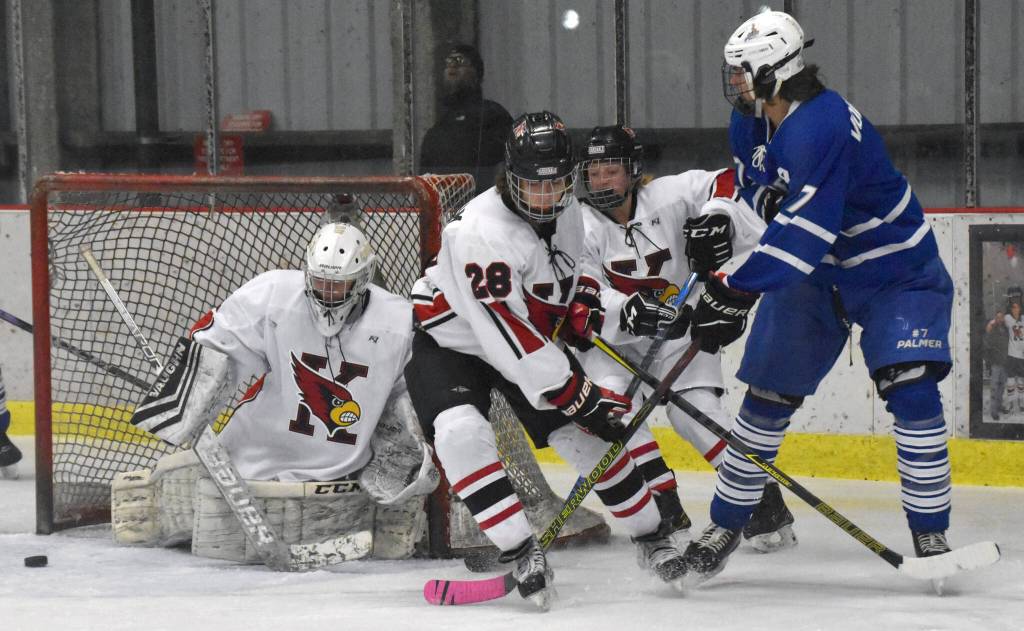 Kenai Central's Seanna Swanson scrambles to make a save while Cole Langham and Kylee Verkuilen hold off Palmer's Elijah Von Gunten on Thursday, Nov. 16, 2023, during Kenai River Cup play at the Kenai Multi-Purpose Facility in Kenai, Alaska. (Photo by Jeff Helminiak/Peninsula Clarion)