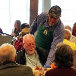 Representatives of Hilcorp distribute Thanksgiving dinners to seniors at the Kenai Senior Center in Kenai, Alaska, on Friday, Nov. 17, 2023. (Jake Dye/Peninsula Clarion)
