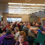 Victoria Askin, right, distributes Thanksgiving dinners to seniors at the Kenai Senior Center in Kenai, Alaska, on Friday, Nov. 17, 2023. (Jake Dye/Peninsula Clarion)