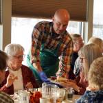 Representatives of Hilcorp distribute Thanksgiving dinners to seniors at the Kenai Senior Center in Kenai, Alaska, on Friday, Nov. 17, 2023. (Jake Dye/Peninsula Clarion)