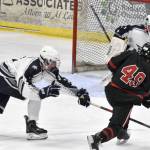 Soldotna defenseman Andrew Arthur and goalie Tanner Clyde work to stop a shot from Juneau-Douglas: Yadaa.at Kales Xavier Melancon on Friday, Nov. 17, 2023, at the Soldotna Regional Sports Complex in Soldotna, Alaska. (Photo by Jeff Helminiak/Peninsula Clarion)