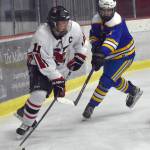 Kenai Centrals Gavin Liles protects the puck from Kodiaks John Paul Pogson on Saturday, Nov. 18, 2023, at the Kenai Multi-Purpose Facility in Kenai, Alaska. (Photo by Jeff Helminiak/Peninsula Clarion)