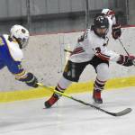 Kenai Central's Will Howard attacks against Kodiak's Theron Glover on Saturday, Nov. 18, 2023, at the Kenai Multi-Purpose Facility in Kenai, Alaska. (Photo by Jeff Helminiak/Peninsula Clarion)
