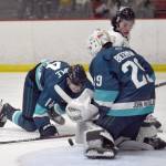 Kenai Rivers Dylan Contreras drives the net against Anchorage Wolverines Jackson Stimple and Liam Beerman on Saturday, Nov. 18, 2023, at the Soldotna Regional Sports Complex in Soldotna, Alaska. (Photo by Jeff Helminiak/Peninsula Clarion)
