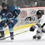 Taisetsu Ushio of the Anchorage Wolverines and Carter Gillen of the Kenai River Brown Bears battle for the puck Saturday, Nov. 18, 2023, at the Soldotna Regional Sports Complex in Soldotna, Alaska. (Photo by Jeff Helminiak/Peninsula Clarion)