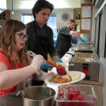 Jesse Lamm, Coltin Yancey and Chef Stephen Lamm plate and serve the Thanksgiving meal at the Kenai Peninsula Food Bank in Soldotna, Alaska, on Wednesday, Nov. 22, 2023. (Jake Dye/Peninsula Clarion)